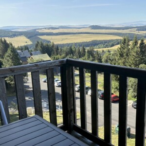 T3 Lamarandière des cimes à Super-Besse, zoom sur la terrasse et vue sur le stationnement extérieur de la résidence